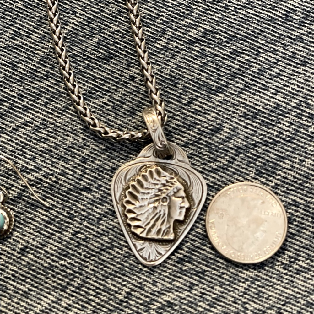 Sterling silver feathered Indian guitar pic necklace. Original box included